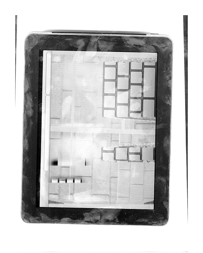 Tablet interface with grid of square keys, photographed within layered frame