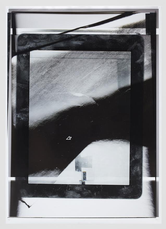 Tablet frame overlaid with dark circular form and horizontal bar